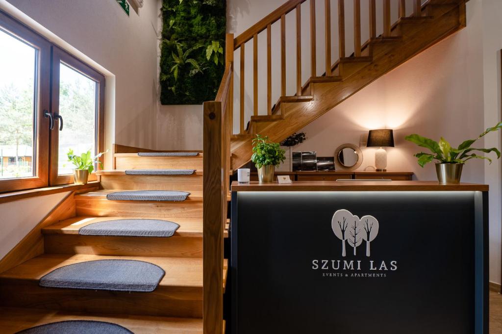 a set of stairs with a sign that reads summit las at Szumi Las Events & Apartments in Regimin