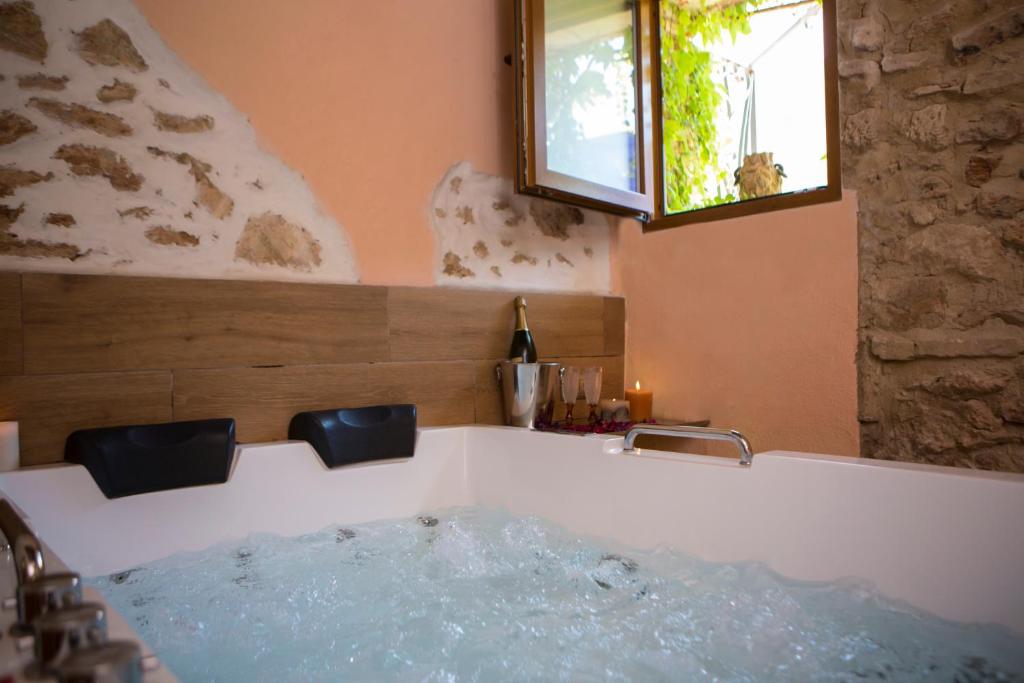 a bath tub with water in it in a bathroom at L'Otelet By Sweet in Valencia