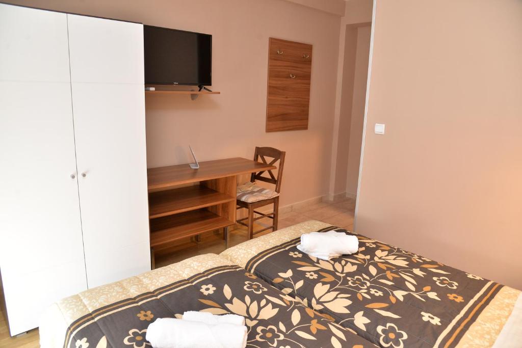 a bedroom with a bed and a desk at Casablanca in Niš