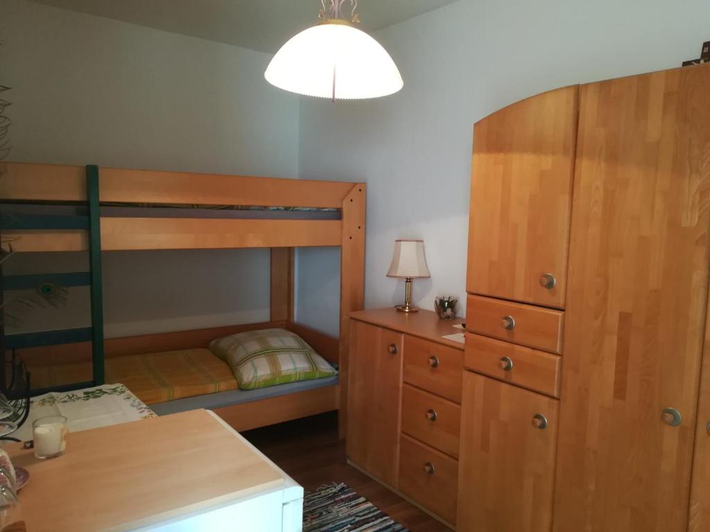 a bedroom with a bunk bed and a dresser at Pension Grafl in Schattendorf