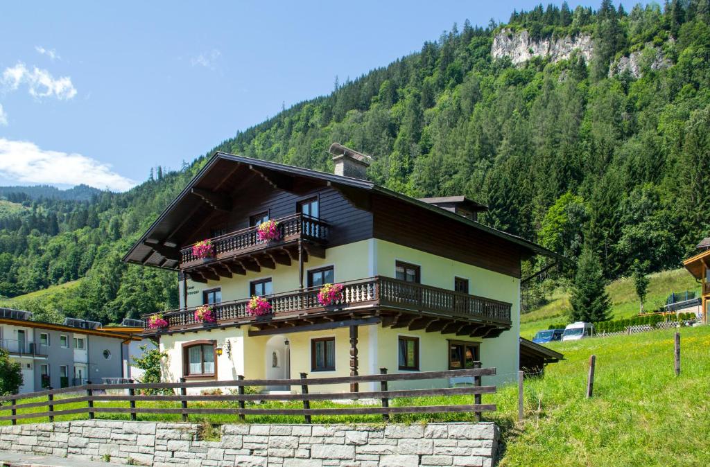 a house with balconies on the side of a mountain at Ferienhaus Alpenrose in Bruck an der Großglocknerstraße