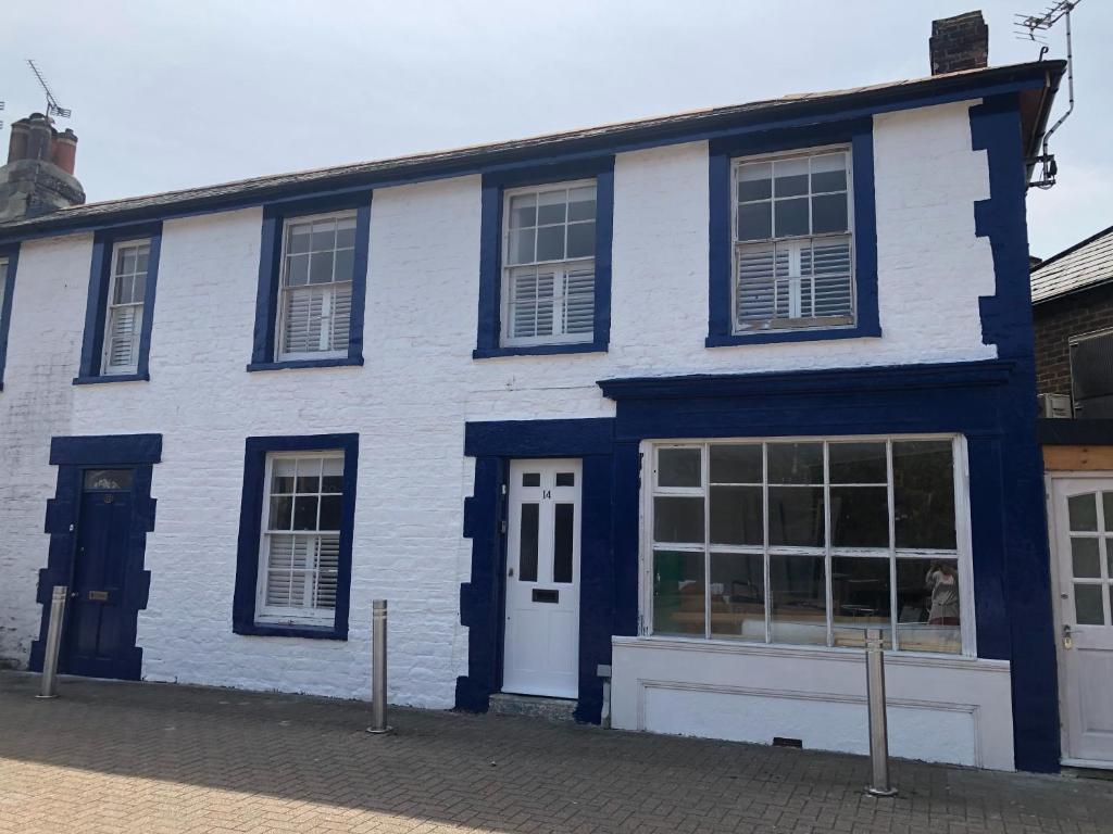 a blue and white building with a white door at Oyster Catchers in Ryde