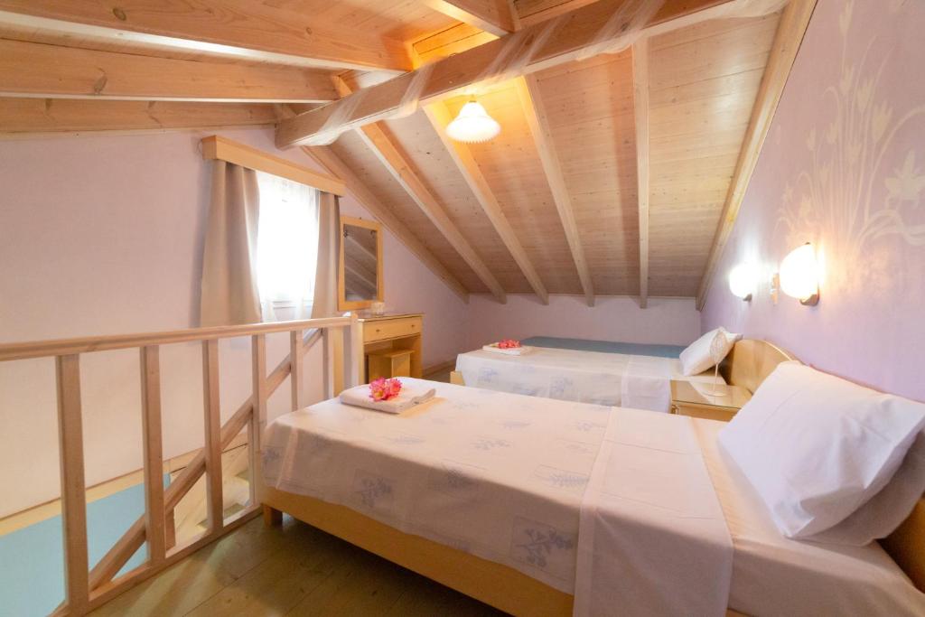 Postel nebo postele na pokoji v ubytování Angelina Apartments