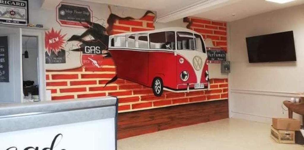 a mural of a bus on the wall of a restaurant at Chambres d'hotes Condat in Condat-sur-Ganaveix