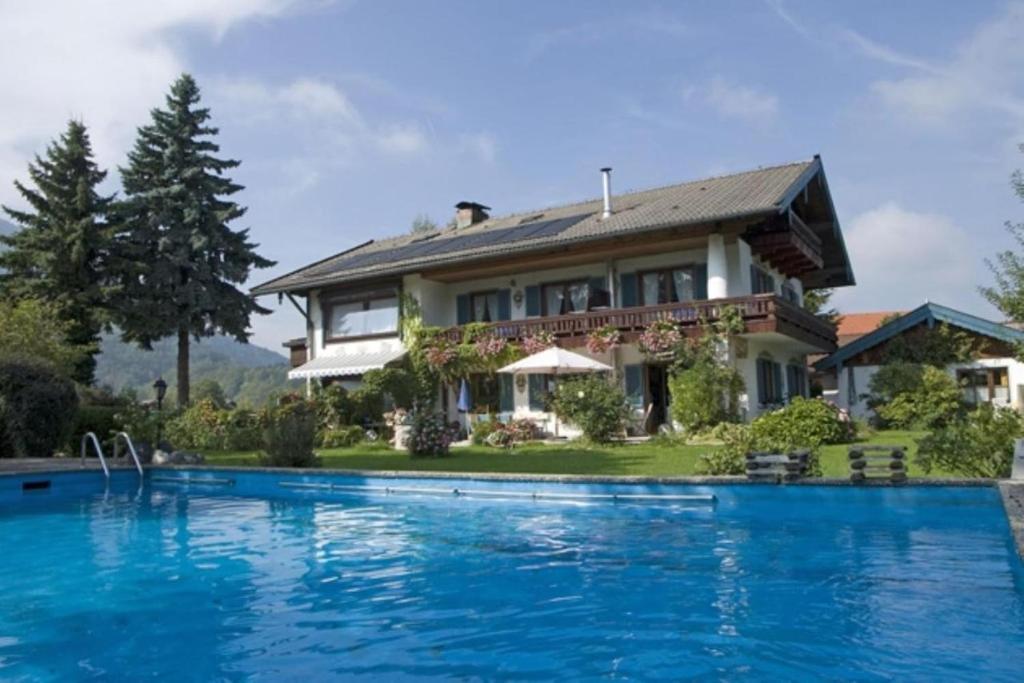 a house with a swimming pool in front of it at Bosch Hermann in Grassau