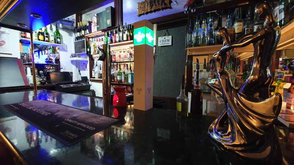 a bar with a statue of a woman on the counter at RockDene in Blackpool