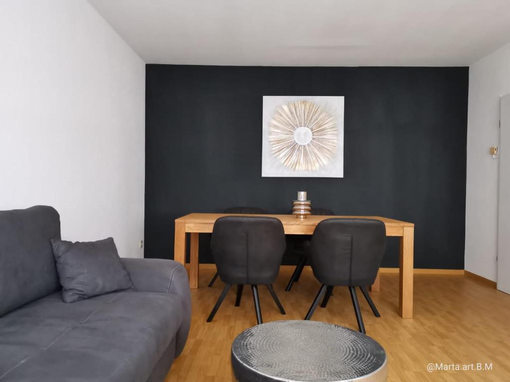 a living room with a table and a couch at Milonia 3 in Bernkastel-Kues