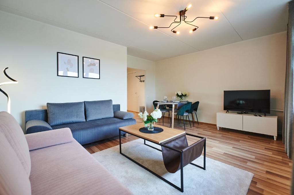 a living room with a couch and a table at Freshly renovated family apartment in Kuressaare