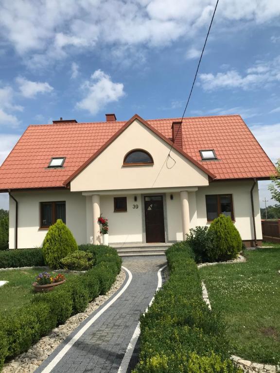 a house with a red roof and a road at Chata u Rodaka in Snochowice