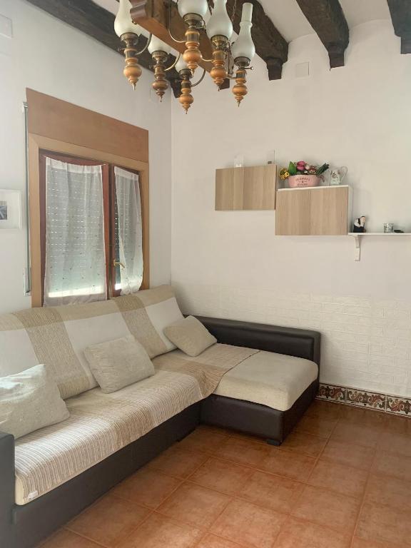 a large couch in a living room with a ceiling at CASA la PAU in Vilassar de Mar