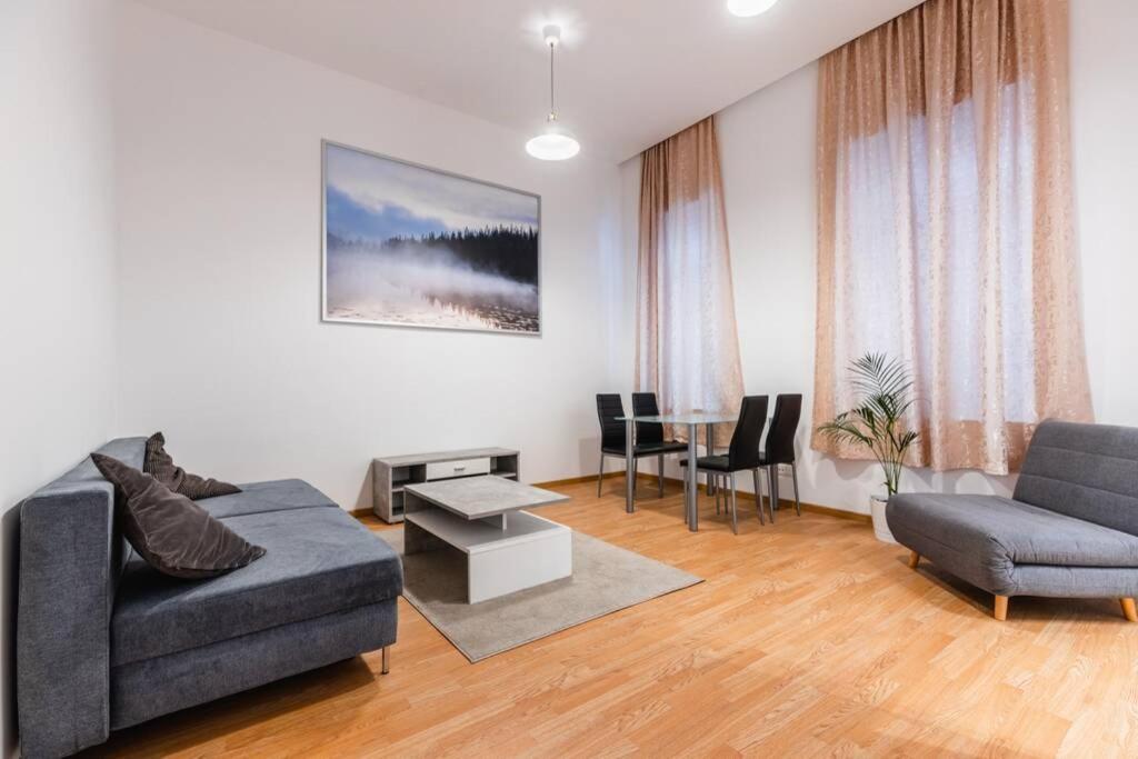 a living room with a couch and a table at Family apartment next to Danube river in Vienna