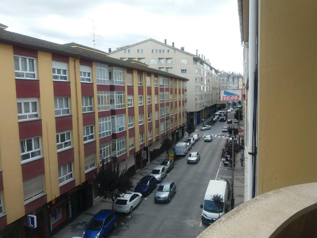 a view from a window of a city street with cars at Apartamento Couto in Ribadeo