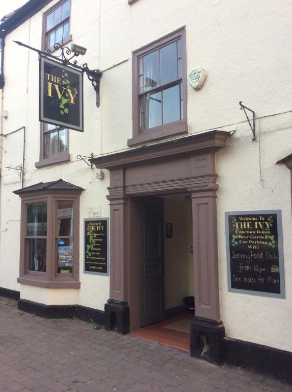 a white building with a sign above a door at The Ivy in Lincolnshire