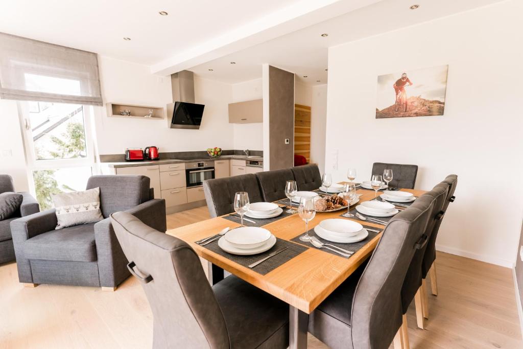 a dining room with a wooden table and chairs at My Lodge Winterberg in Winterberg