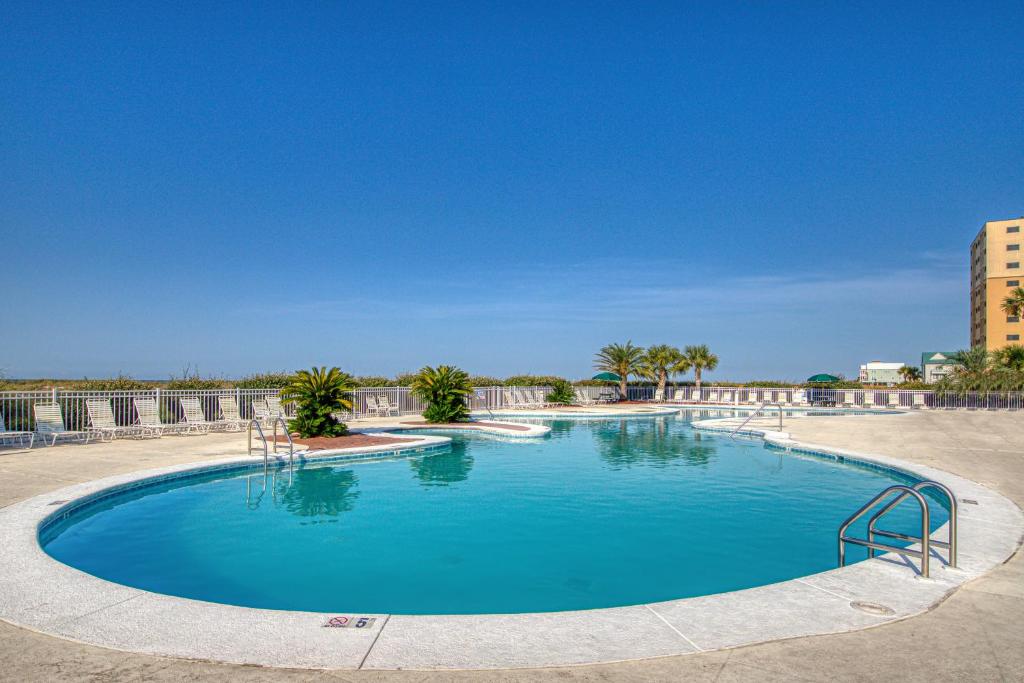 a large swimming pool with blue water at Plantation East III in Gulf Shores