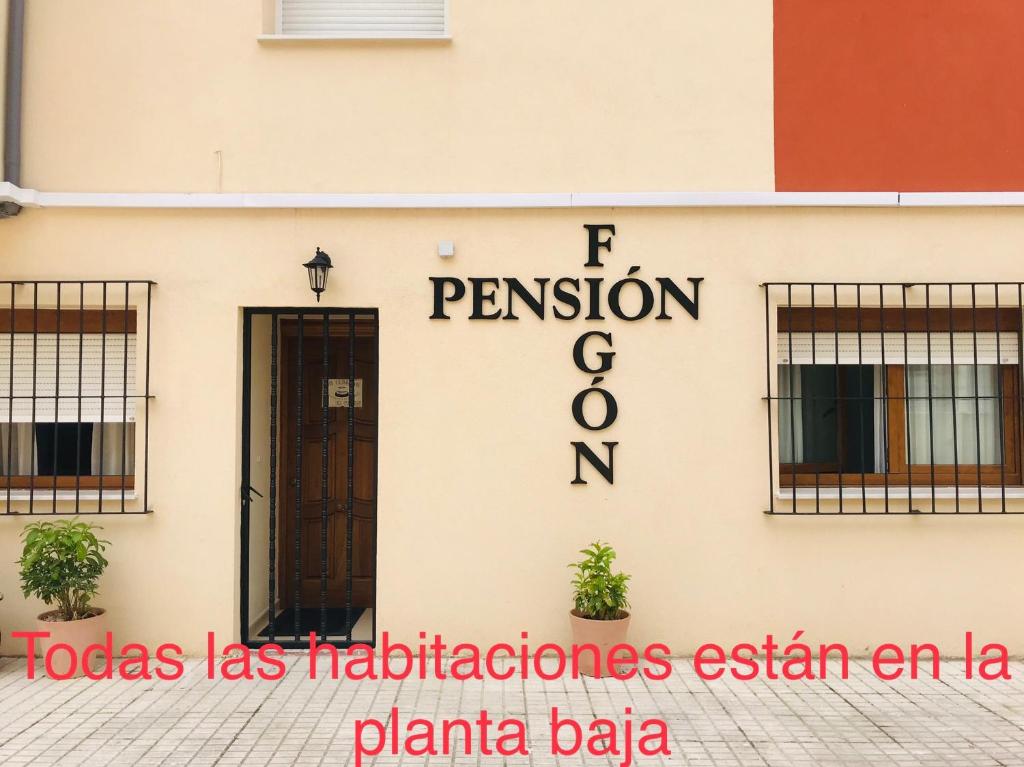 a sign on the side of a building at Pension El Figon in Santander