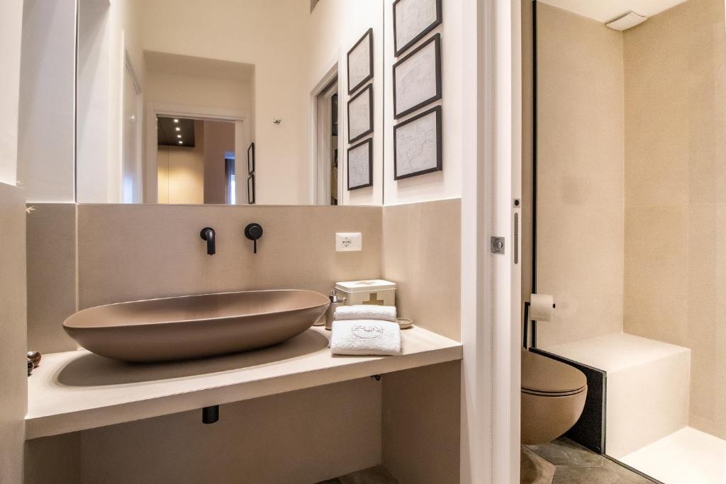 a bathroom with a large bowl sink on a counter at Zisa Suite in Palermo