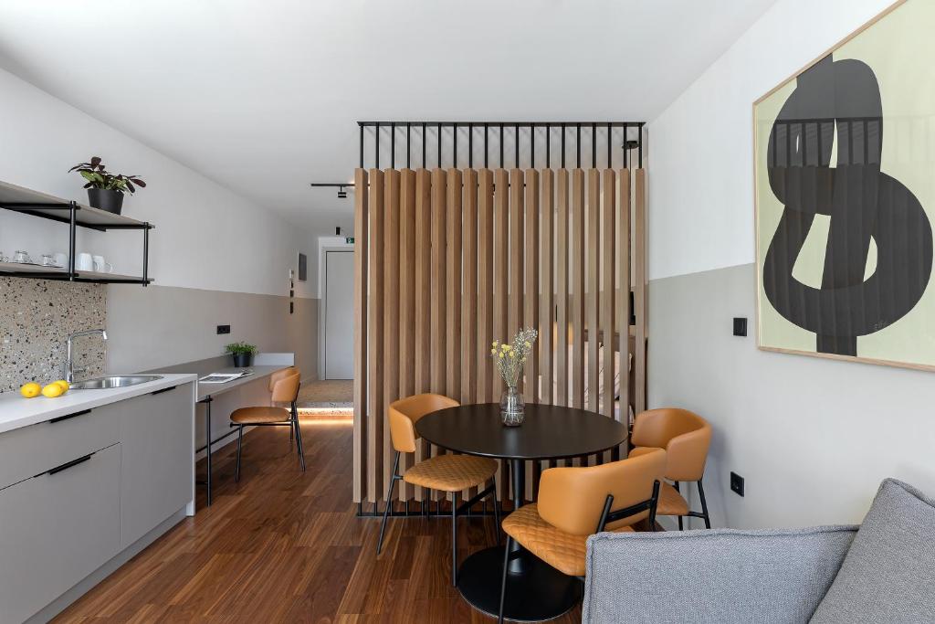 a kitchen and dining room with a table and chairs at The Athenians Art Apartments in Athens