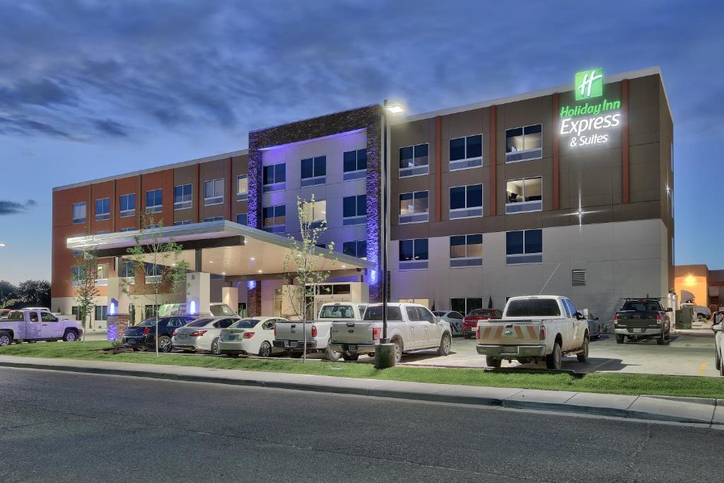 a hotel with cars parked in front of a building at Holiday Inn Express & Suites - Roswell, an IHG Hotel in Roswell