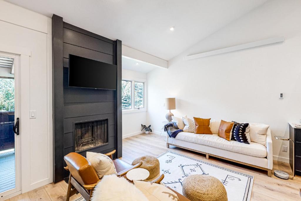 a living room with a couch and a fireplace at Fish Creek Point in Wilson