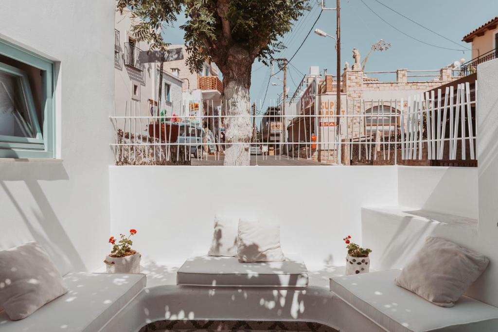 a white room with two sinks and a tree at Lilika's Luxury Maisonette by Estia in Hersonissos