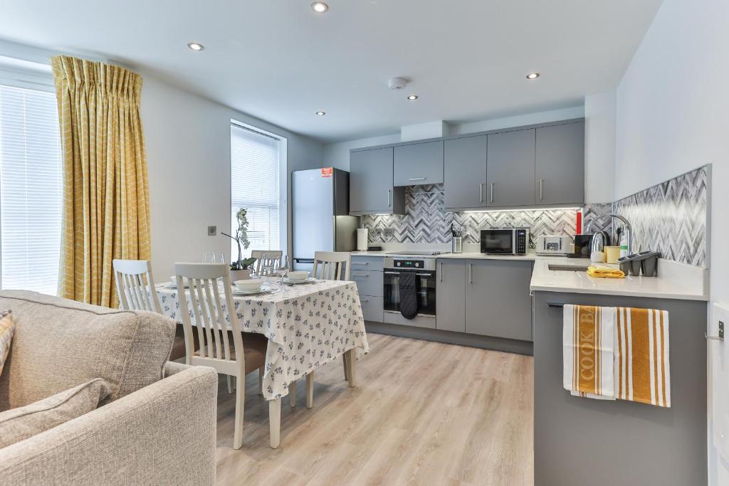 a kitchen and dining room with a table and chairs at Finest Retreats - Belle House, Apt 6 in Filey