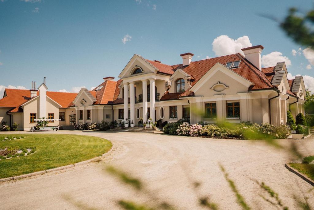 a large house with a driveway in front of it at Winny Dworek in Sulechów