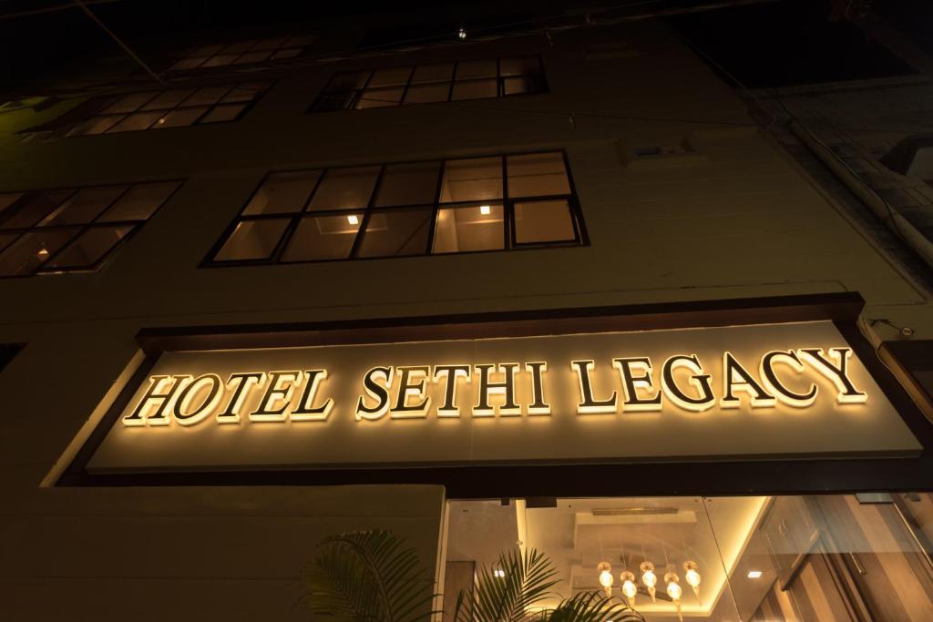 a sign on the front of a hotel serif legacy at Hotel Sethi Legacy in Haridwār
