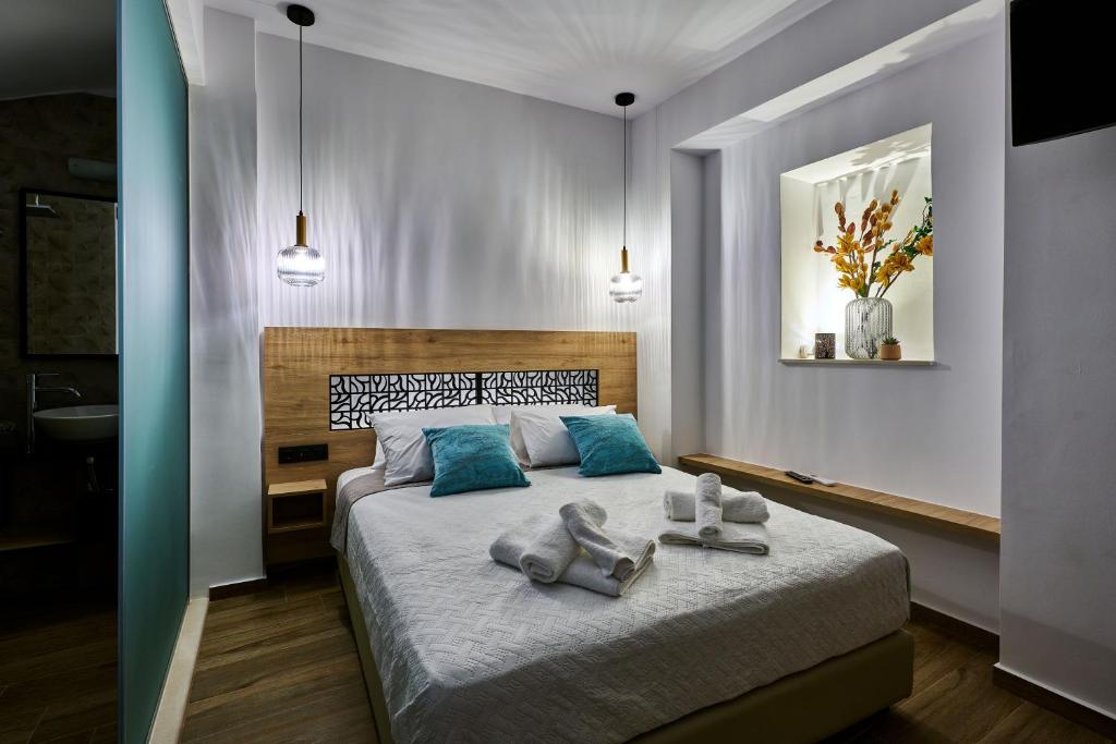 a bedroom with a bed with towels on it at City Experience Apartments A in Heraklio Town