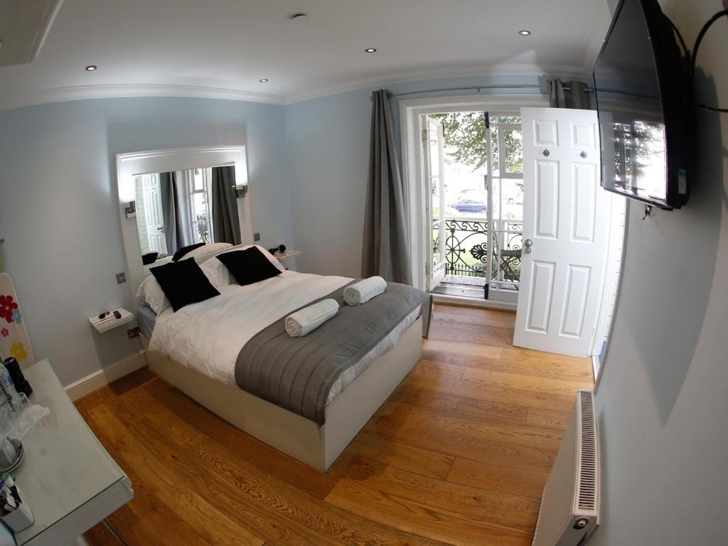 a bedroom with a bed and a sliding glass door at Churchill Brighton in Brighton & Hove