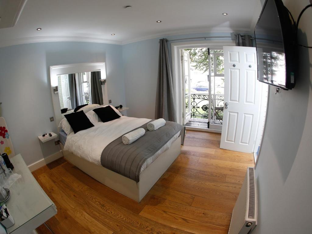 a bedroom with a bed and a sliding glass door at INNit Joy in Brighton & Hove