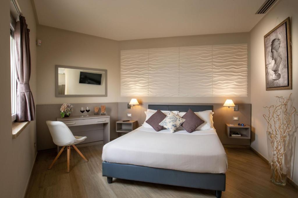 Postel nebo postele na pokoji v ubytování Hotel Miramare