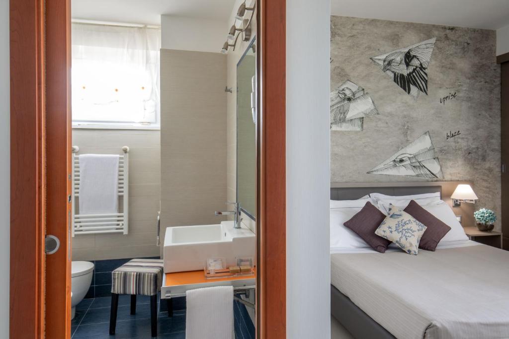 Postel nebo postele na pokoji v ubytování Hotel Miramare