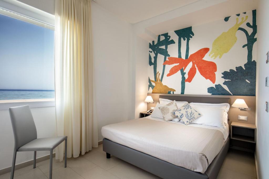 Postel nebo postele na pokoji v ubytování Hotel Miramare