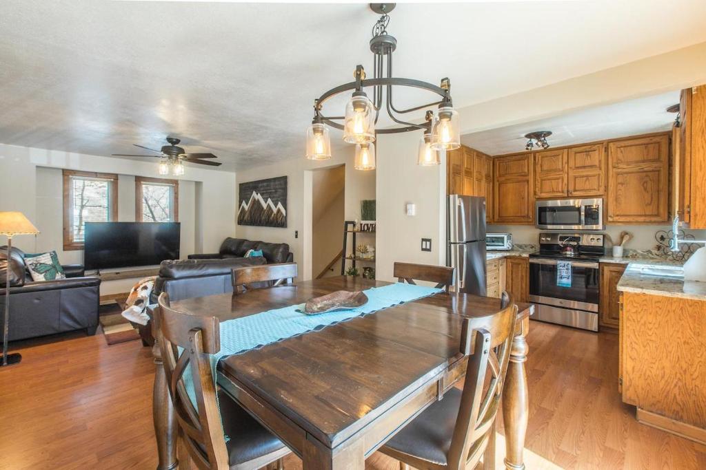 Una cocina y un comedor con una mesa de madera. en River Park 1241, en Ouray