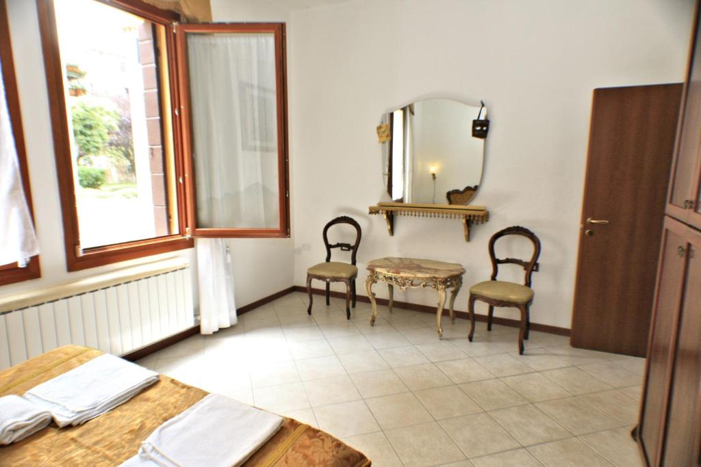 Posteľ alebo postele v izbe v ubytovaní Queen House Venezia