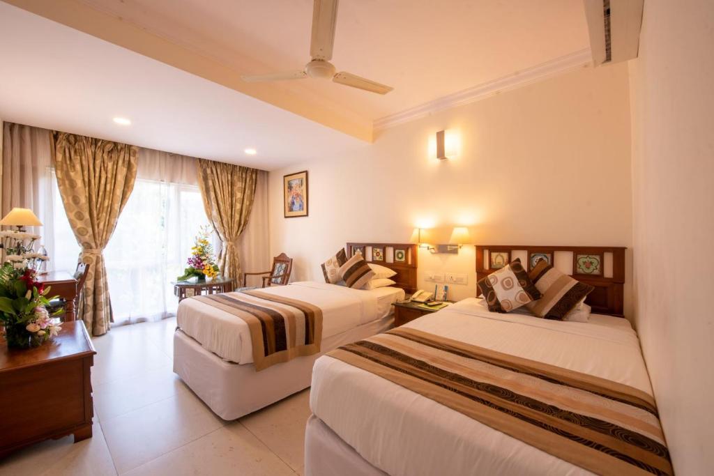 Postel nebo postele na pokoji v ubytování La-Paz Gardens Beacon Hotel - Vasco da Gama Goa