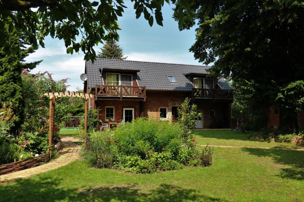 a house with a garden in front of it at Ferienwohnung im Spreewald in idyllischer Alleinlage in Werben