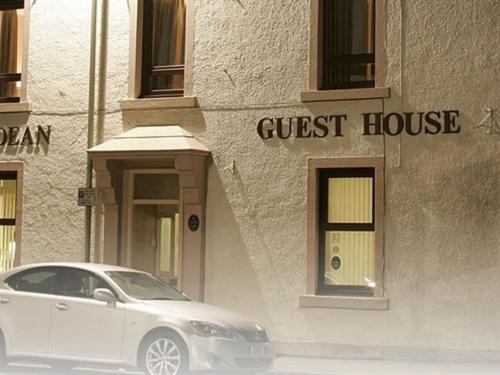 a white car parked in front of a guest house at Hebridean Guest House in Stornoway
