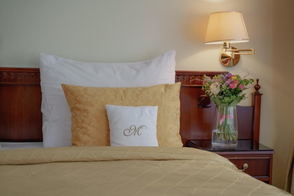 Postel nebo postele na pokoji v ubytování Hotel Mignon