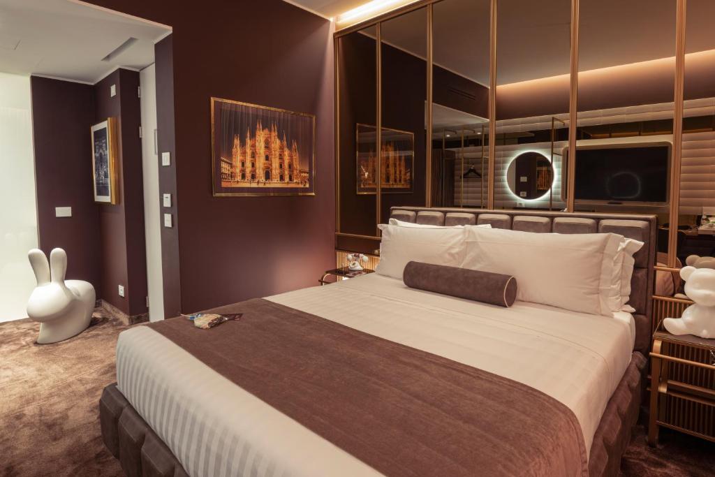 a bedroom with a large bed and a large window at ODSweet Duomo Milano Hotel in Milan