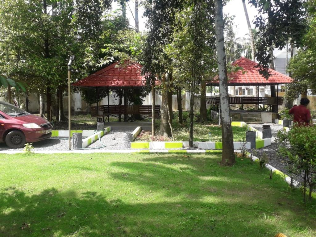 a park with a pavilion and a gazebo at Stylehomes The Farm House Inn (Heritage Resort) in Lokamaleswaram