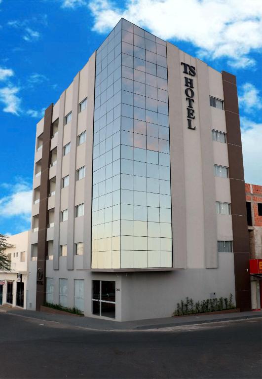 a large building with a sign on the side of it at TS HOTEL in Porteirinha