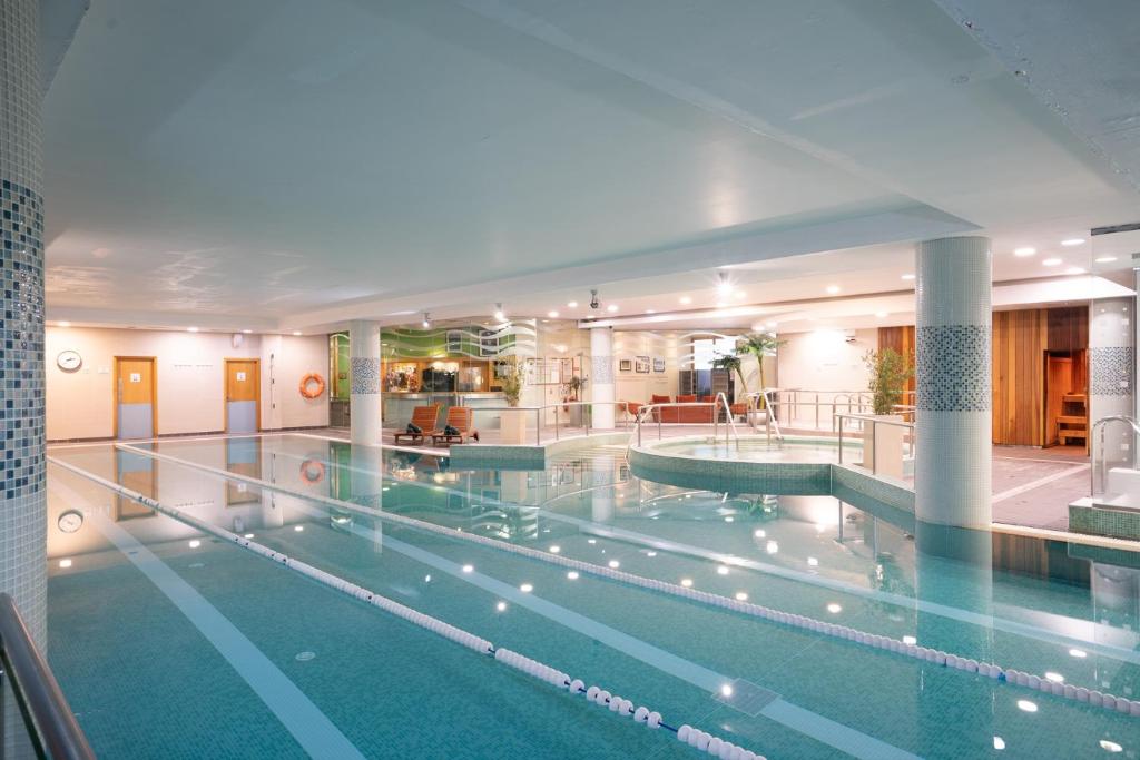 a large swimming pool in a hotel building at Limerick Strand Hotel in Limerick
