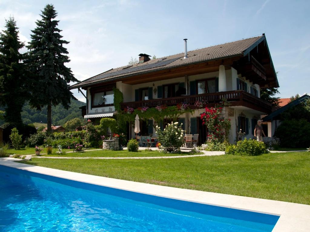 a house with a swimming pool in front of it at Gästehaus Gamsei - Bosch Hermann in Grassau