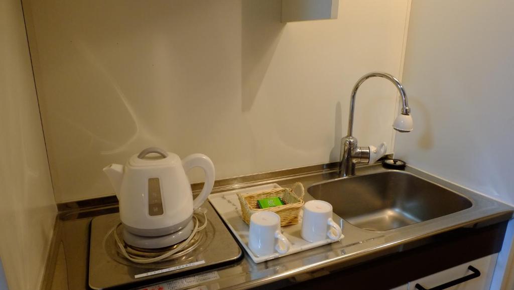 Kuchyň nebo kuchyňský kout v ubytování Sawa Hotel