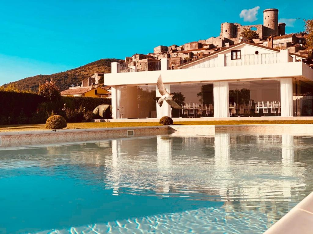 a villa with a swimming pool in front of a house at Il Casale di Riardo Luxury B&B in Riardo