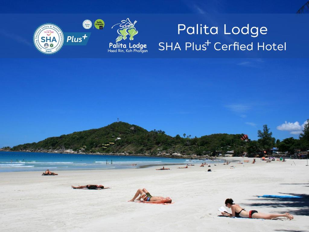 a picture of a beach with people laying on the sand at Palita Lodge - SHA Plus in Haad Rin