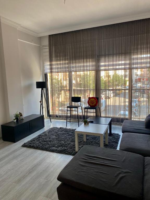 a living room with a couch and a table at carsi house in Kuşadası