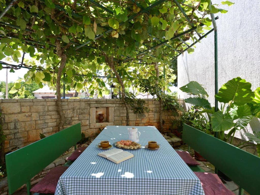 a blue table with a plate of food on a patio at Holiday Home Milka 1 - ROJ315 by Interhome in Svetvinčenat